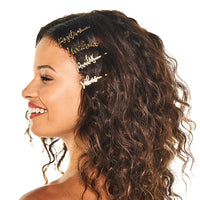 Smiling woman with shoulder-length, wavy brown hair wearing gold On The Go barrettes stacked at the side of her head
