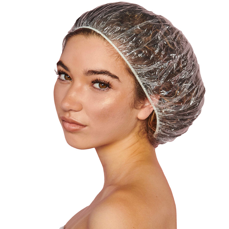Woman wearing a clear disposable shower cap with elastic trim, covering all of her hair