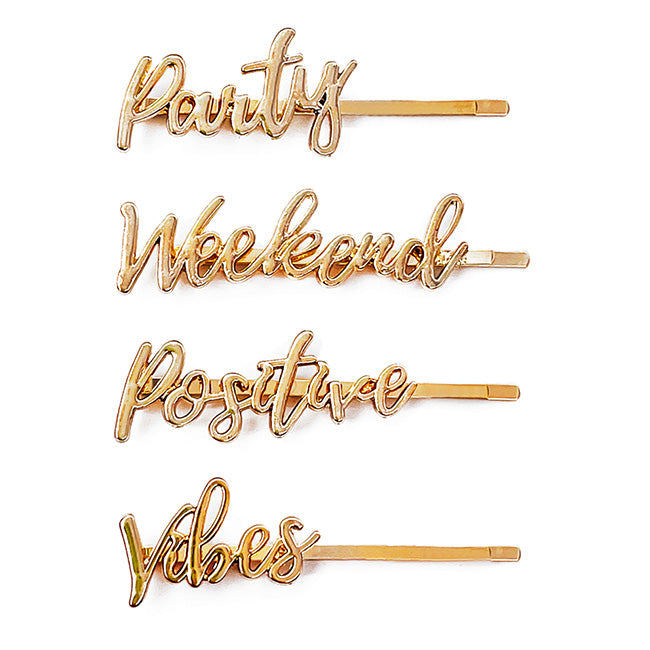 Four gold On The Go barrettes with the words “Party,” “Weekend,” “Positive,” and “Vibes” in script lettering