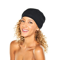 Smiling woman with curly hair wearing the black Satin-Lined Jersey Beanie