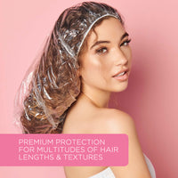 Woman with long, curly hair wearing the clear processing cap against a pink background, with the text “Premium protection for multitudes of hair lengths & textures”