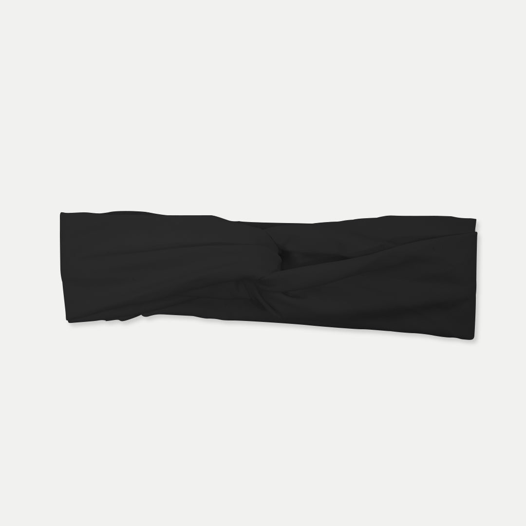 Black Fitband headband laid flat, showing its twist-front design