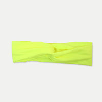 Neon yellow Fitband headband laid flat, showing its twist-front design